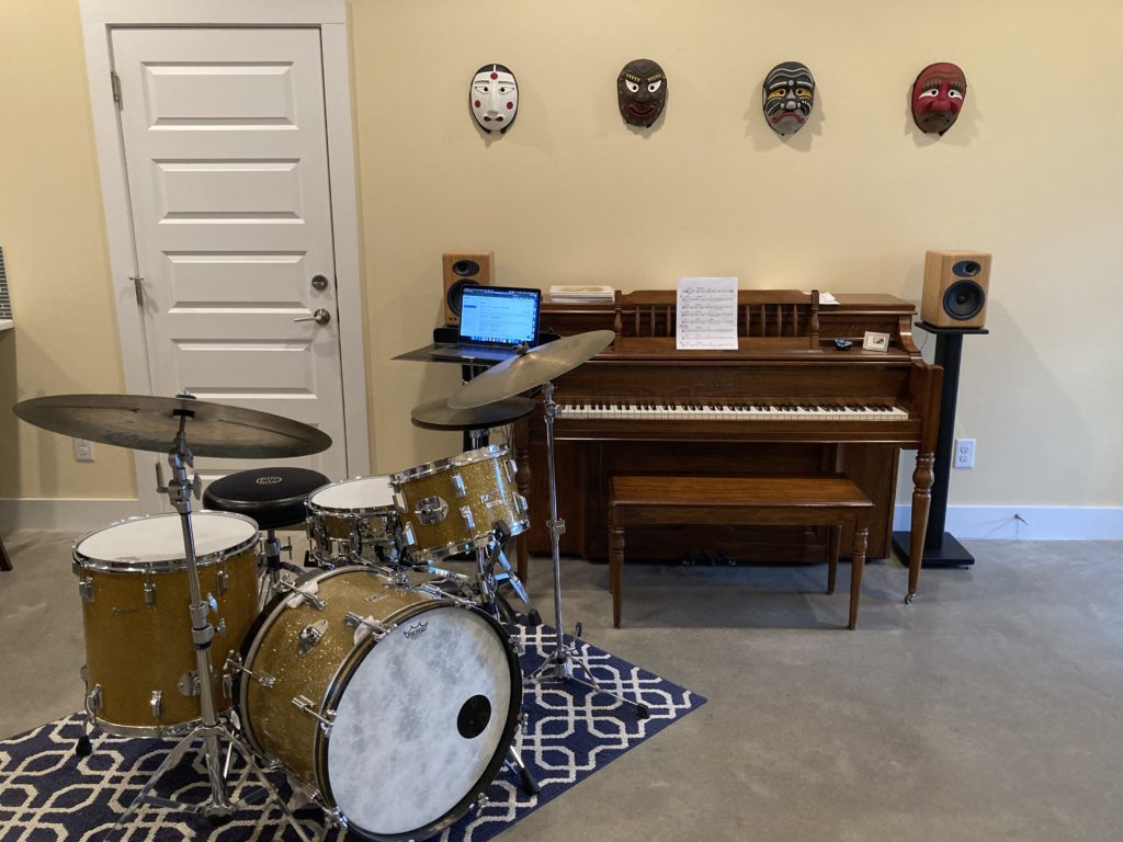 home studio with piano and drum kit