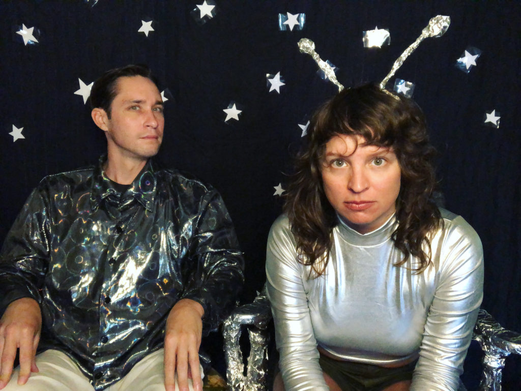 bandmates in front of spacey background