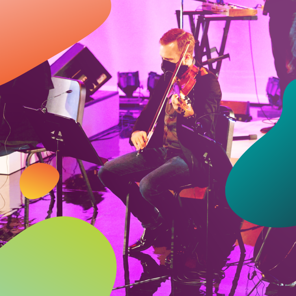 string player on stage with purple lights