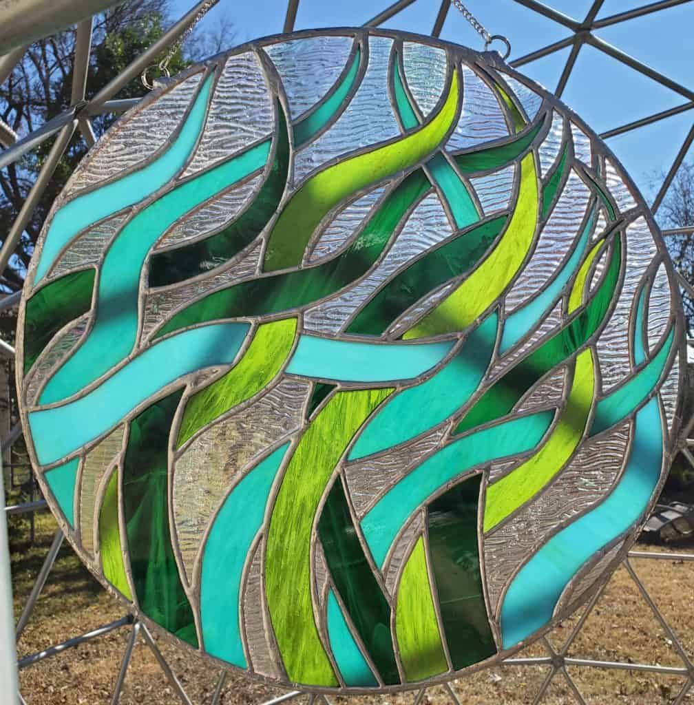 Fused glass artwork in green grass-like pattern