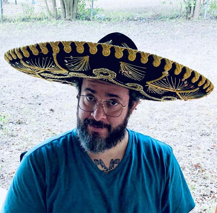 Bobby with a curious look on his face, wearing a black and gold sombrero.