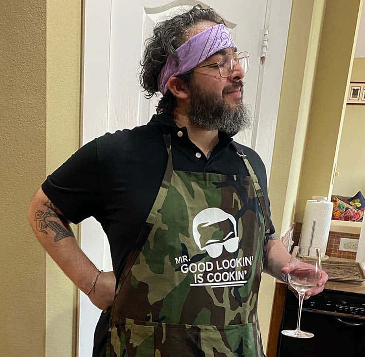 Bobby in the kitchen wearing an apron and ready to cook