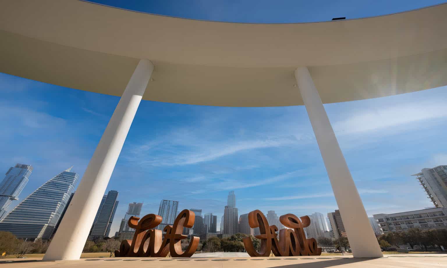 LOVE HATE sits under the Long Center ring beam with the Austin skyline in the background
