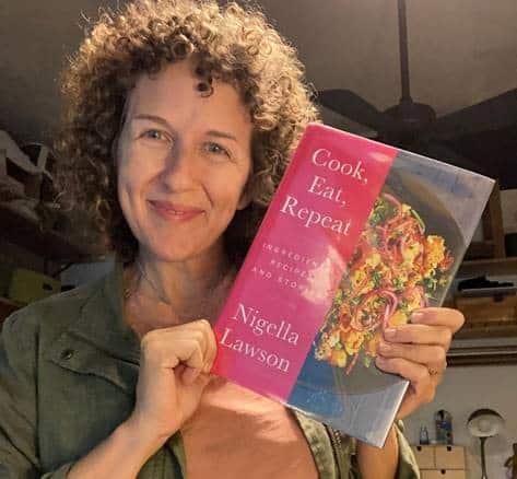 Addie Broyles poses with Nigella Lawson's latest cookbook release, Cook Eat Repeat